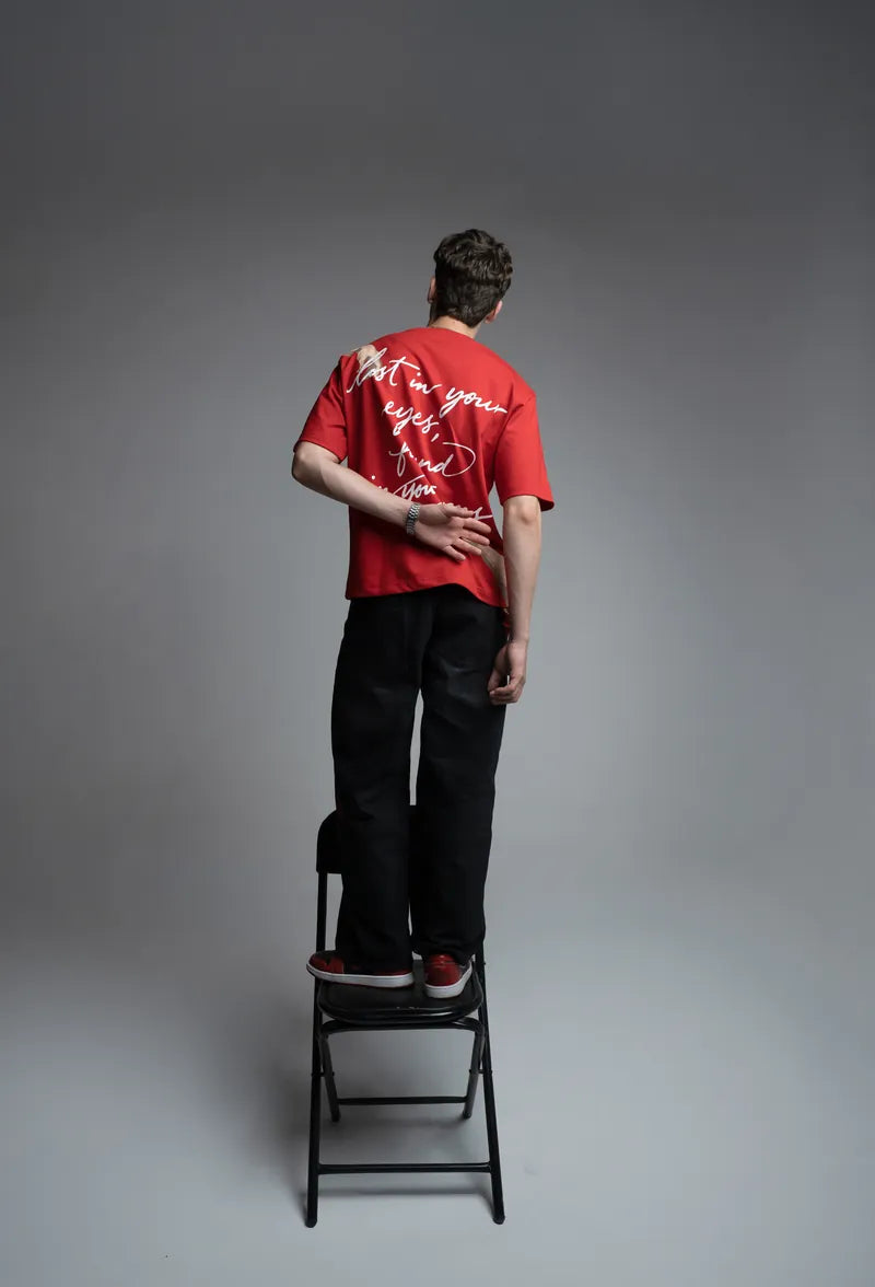Standing on a step stool in the red Lost Tee, full back print visible